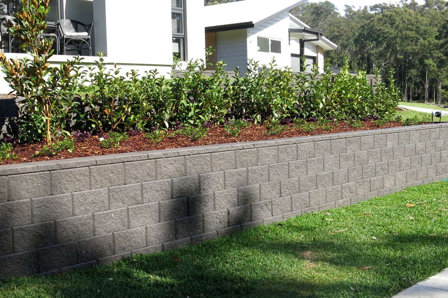A tiered segmental block retaining wall built by Novascape at Cameron Park