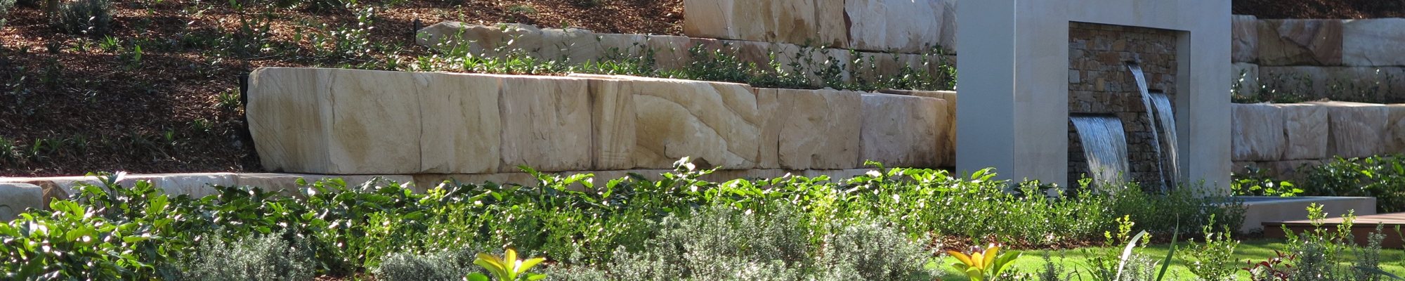 Novascape constructed this large sandstone log wall for McDonald Jones homes